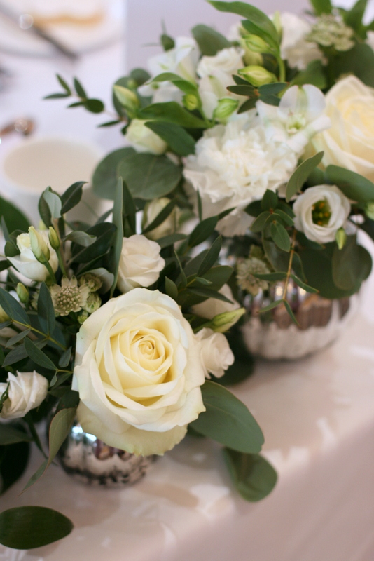 Wedding flowers in ivory, cream and white flowers with green foliage at Richmond Hill Hotel